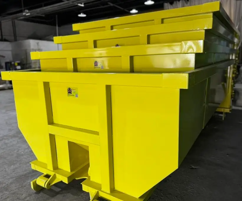 RapidPolk Dumpster Rental yellow dumpsters neatly arranged indoors for upcoming delivery needs