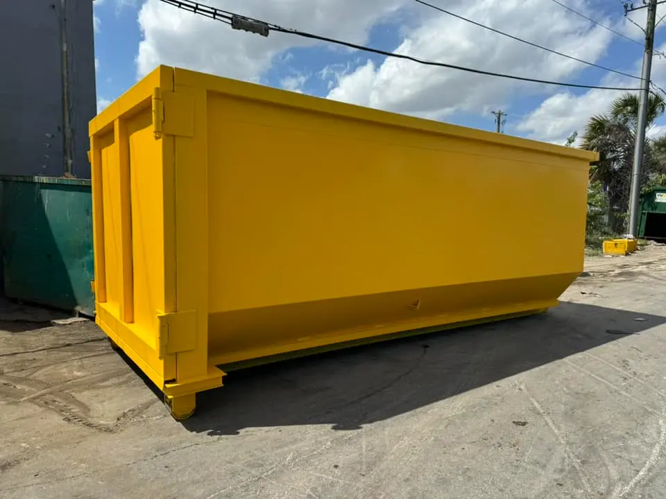 Residential dumpster rental by RapidPolk delivers empty yellow dumpster to residential street