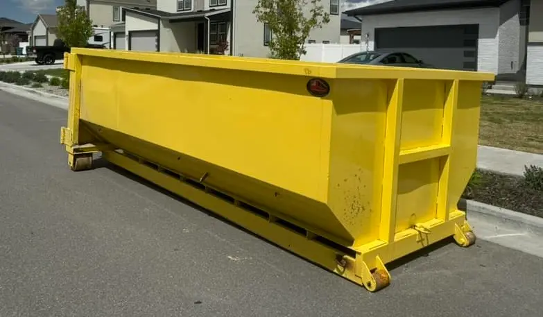 Residential dumpster rental by RapidPolk places yellow rolloff dumpster for household cleanup project